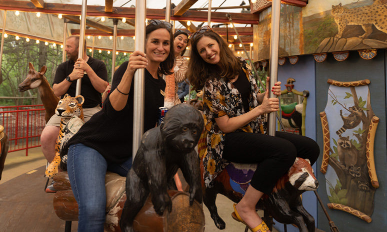 echo attendees riding a carousel